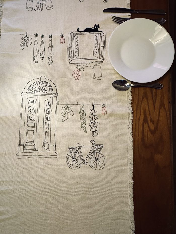 The Shababeek table runner laid on a wooden table