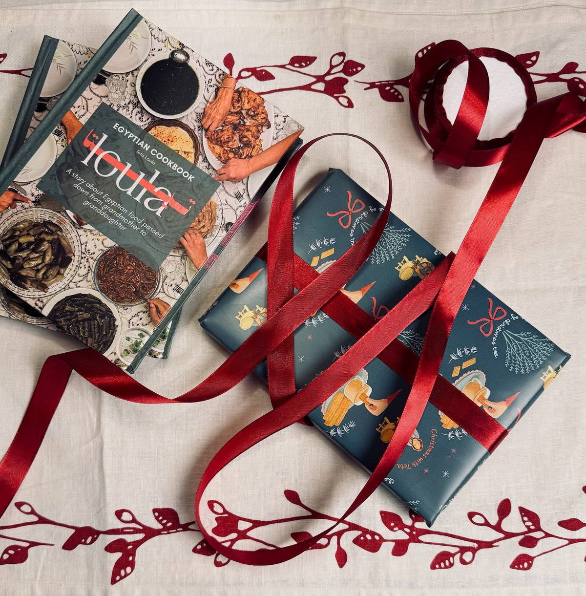 Teta Loula cookbook wrapped as a gift with red ribbon